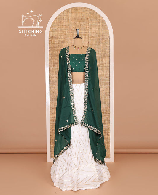 Cream-green half-saree, gold chevron striped nylon viscose crepe skirt, contrast diamond buttas blouse, and  a contrast scallop floral-theme embroidered dhavani