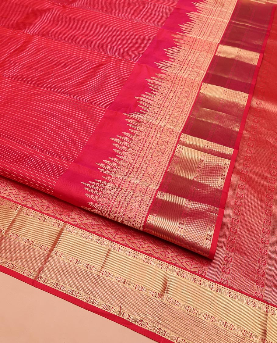 Red Vasundhara Silk Saree, Gleamed Up with Zari Muthu Stripes on Its Body, Highlighted by Zari Border of Traditional Designs, Geometric-Patterned Pallu, and Paired with a Matching Blouse