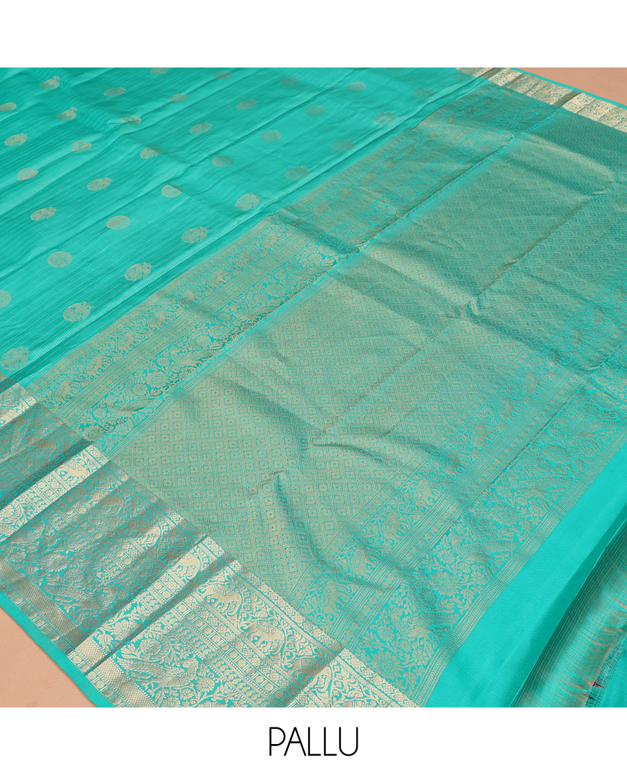 Blue Vasundhara Silk Saree, Accentuated with Zari Buttas and Stripes, a Zari Border of Kathir, Yaanai, Rudraksham, Manga, and Mayil Design, a Grand Pallu, and a Matching Blouse