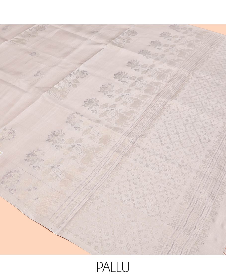 Borderless Cream Mayuri Soft Silk Saree, Sparsely Woven with Pichwai Lotus and Cow Buttas All Over Its Body, Highlighted by Pallu of Pichwai Designs, and Paired with a Matching Blouse