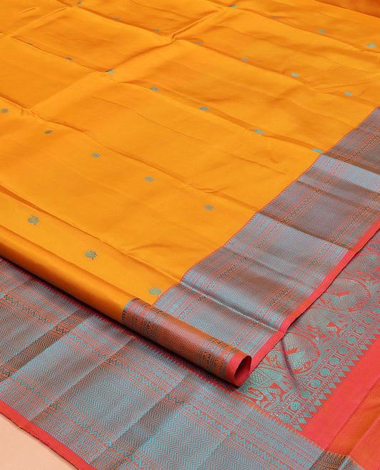 Yellow Kanchipuram Silk Saree, Decked Up with Mayil-Chakram Buttas on Its Body, Complemented by a Contrast Border of Rekku, Banaras, Rudraksham, Neli, and Vanki Designs, Pallu Steeped with Kamalam Designs, and Paired with a Contrast Blouse