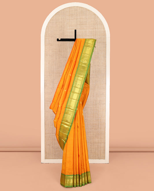 Orange Kanchipuram Silk Saree, Enriched with Zari Buttas on Its Body, Complemented by a Contrast One-Sided Border of Panner Sombu, Banaras, Muthu, and Mayil Kann Designs, Pallu of Zari Designs, and Comes Without a Blouse