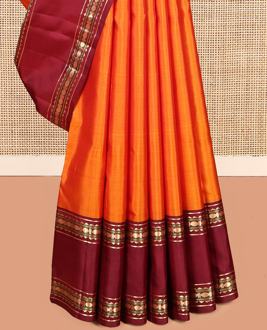 Orange Plain Kanchipuram Silk Saree, Complemented by a Contrast Rettai Pettu Border of Rekku, Muthu, and Poun Designs, Seppu Rekku Pallu, and a Contrast Blouse