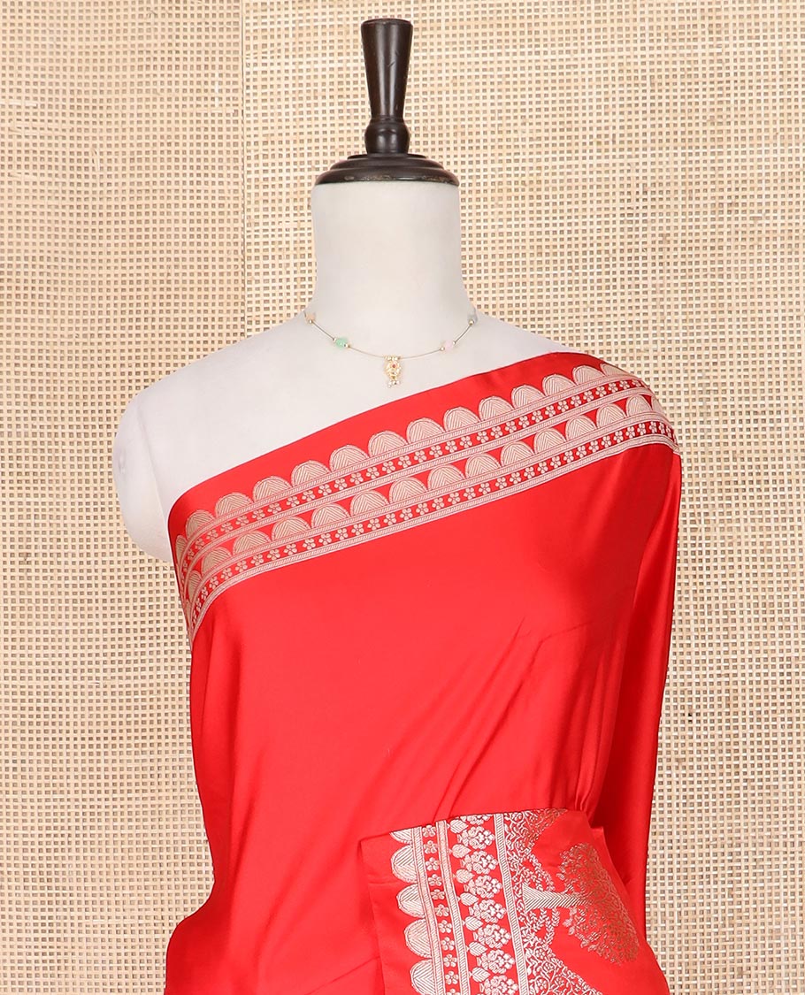 Red plain mushru silk saree, self-border of scallop design, floral, and tree motifs, and intricately designed pallu