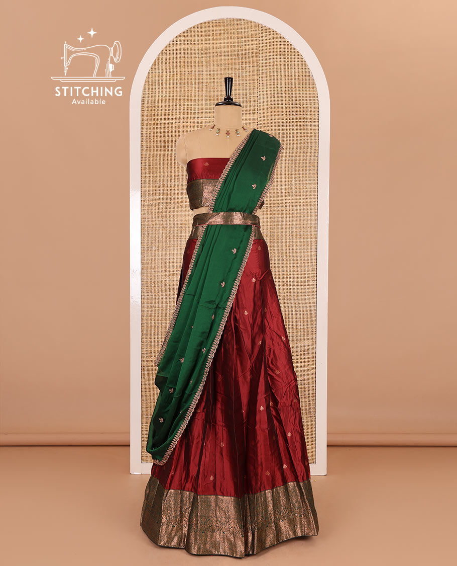 Maroon taffeta silk half-saree, zari buttas with contrast traditional zari bordered skirt, matching zari design blouse, and contrast scallop buttas embroidered dhavani
