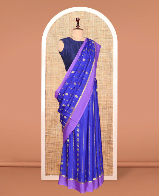 Blue Mysore Silk Saree, Gracefully Decked Up with Peacock Buttas and Stripes Across Its Body, Complemented by Contrast Border, Pallu Steeped with Traditional Zari Designs, and Paired with a Contrast Blouse