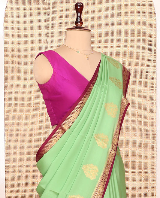 Green Mysore Silk Saree Prettified with Zari Buttas All Over Its Body, Complemented by Captivating Contrast Border of Traditional Zari Designs, Zari Designs Woven Pallu, and Paired with a Contrast Blouse
