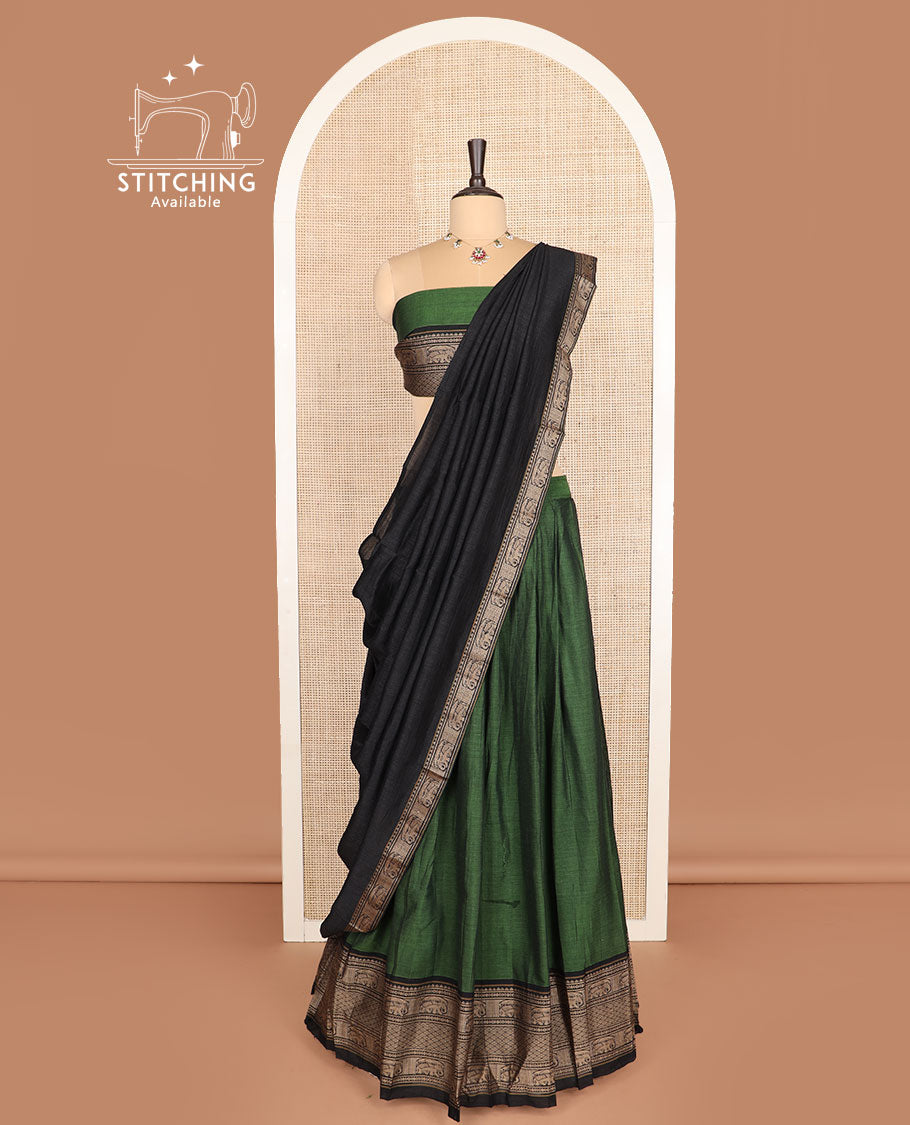 Green cotton half-saree, plain with contrast traditional motifs woven bordered skirt, matching blouse, and a contrast bordered dhavani