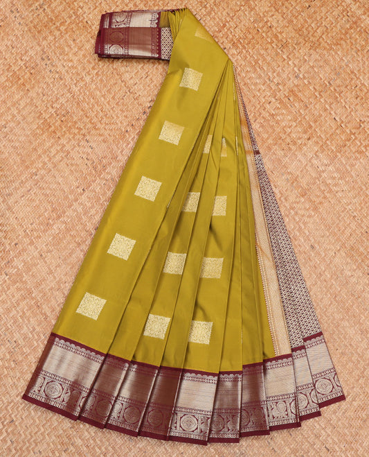 Green Budget Silk Saree, Detailed with Zari Buttas All Over Its Body, Complemented by a Contrast Traditional Zari Design Border of Peacock-Chakram Designs, Subtle Jaal Pallu, and Paired with a Contrast Blouse