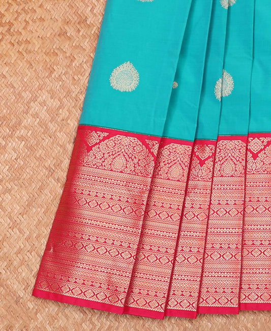 Blue Budget Silk Saree Decorated with Zari Buttas, Complemented by a Contrast Traditional Zari Motifs  Steeped Border, Pallu Mirrors the Same Border Motifs, and Paired with a Contrast Blouse