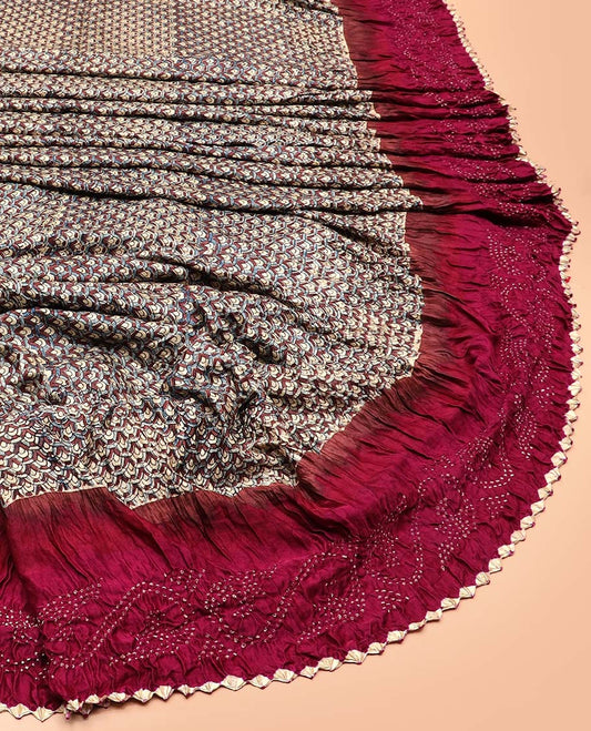 Beige scallop printed bandhani silk saree, contrast bandhani dotted border, and dots enclosed thick zari checked pallu