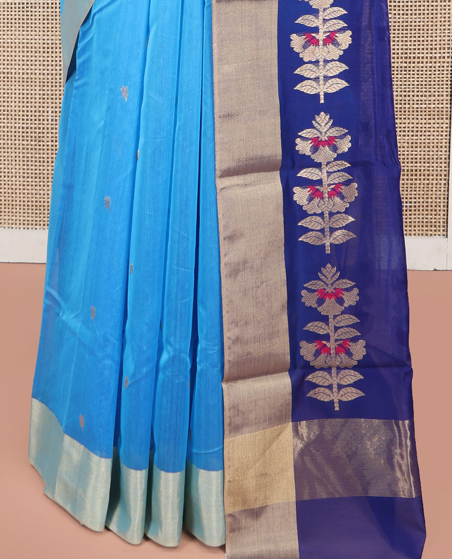 Blue Chanderi Cotton Saree, Subtly Sparkled with Buttas All Over Its Body, Subtly Woven Bavanji Border, Complemented by a Contrast Pallu Steeped with Floral Designs, and Paired with a Contrast Blouse