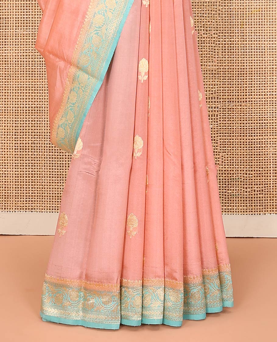 Peach Raw Mango Silk Saree Bedecked with Buttas, Features a Contrast floral creeper design Border, adorned with intricately designed Pallu, and comes with a Contrast Blouse