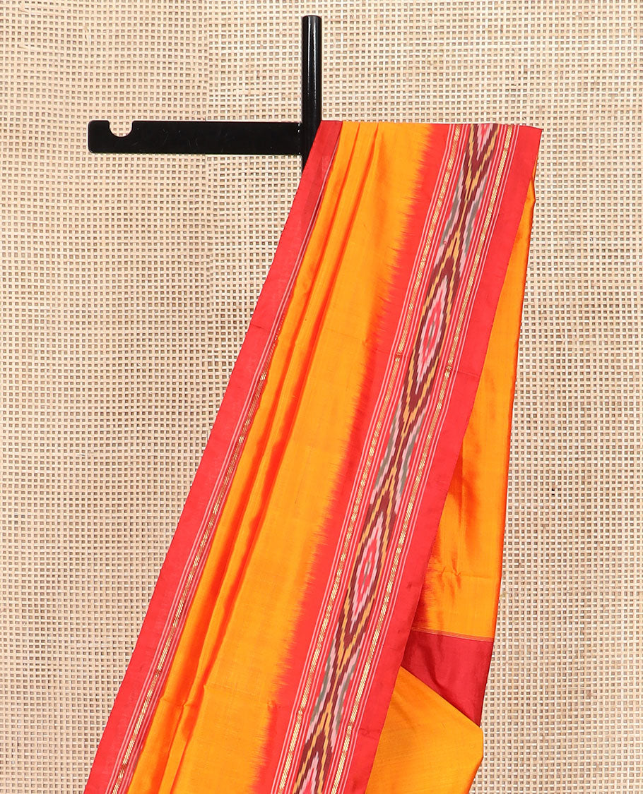 Orange Plain Ikkat Silk Saree with a Contrast Red Border Adorned by a Hazy Ikkat Weave, Featuring a Pallu Flanked by Stripes and Ikkat Texture