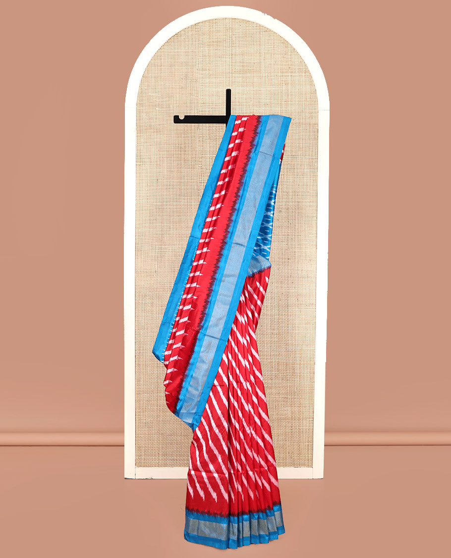 Red Pochampally Ikat Silk Saree, Delicately Woven with Stripes on Its Body, Complemented by a Contrast Border of Stripes, Pallu of Butta Enclosed Jaal Designs, and Paired with a Contrast Blouse