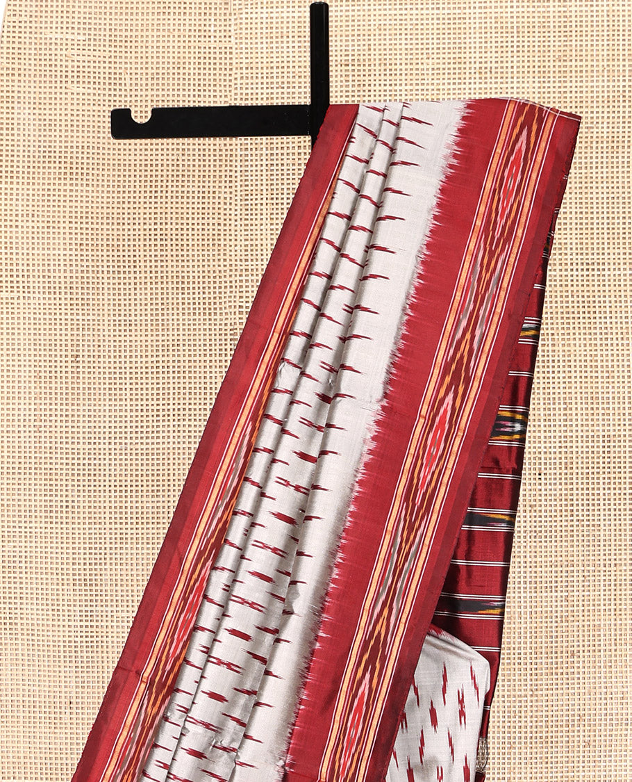Grey-Red Pochampally Ikat Silk Saree, Adorned with Ikat Buttas, Complemented by a Contrast Ikat Border, Ikat-Style Pallu, and No Blouse