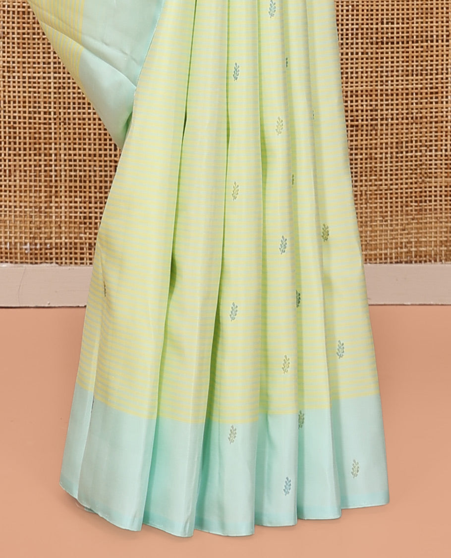 Green Kanchipuram Silk Saree, Subtly Sparkled with Stripes and Thread Buttas, Complemented by a Contrast Border, Jaal Pallu, and Contrast Blouse