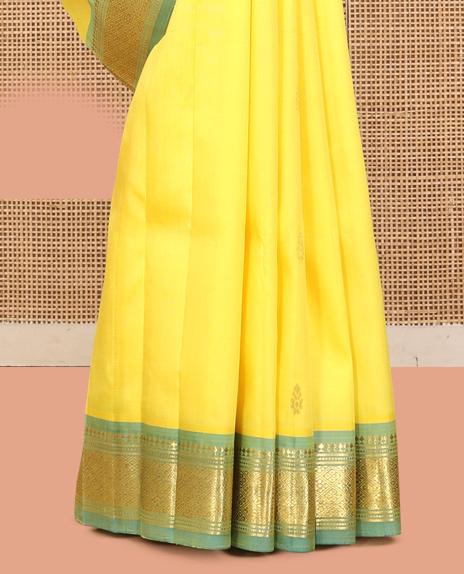 Yellow Kanchipuram Silk Saree, Sparsely Sparkled with Zari Buttas, a Contrast One-Sided Border of Panner Sombu, Banaras, Muthu, and Jaal Designs, a Zari Design Pallu, and No Blouse