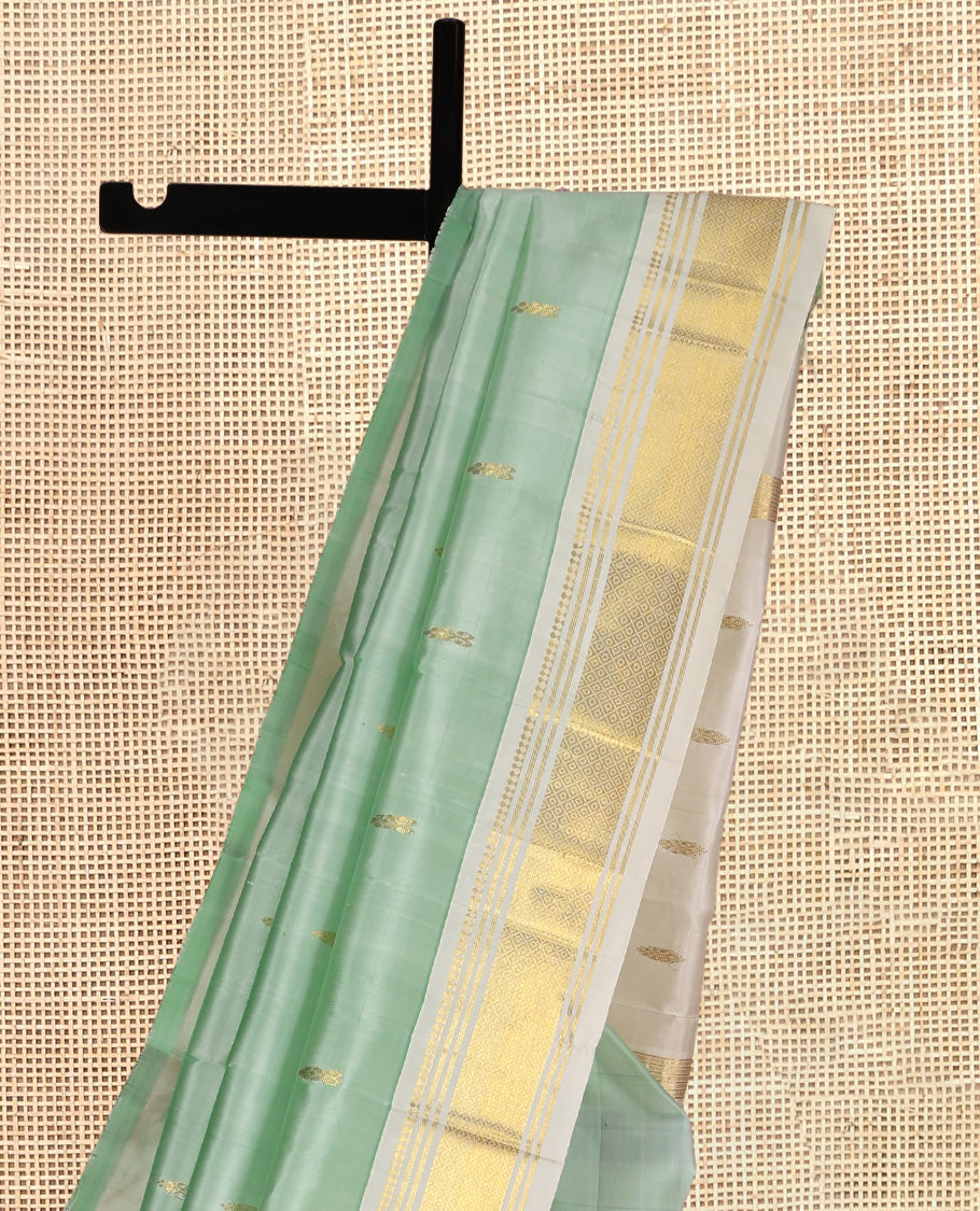 Pale Green Kanchipuram Silk Saree, Woven with Zari Buttas, Complemented by a Contrast One-Sided Border of Panner Sombu, Banaras, and Mayil Kann Designs, Zari Woven Pallu, and a No Blouse