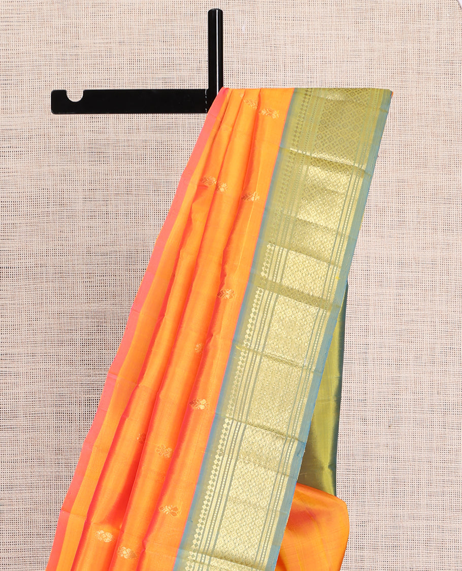 Orange Kanchipuram Silk Saree, Ornamented with Zari Buttas, a Contrast One-Sided Border of Paneer Sombu, Banaras, Muthu, and Jaal Design, Zari Design Pallu, and No Blouse