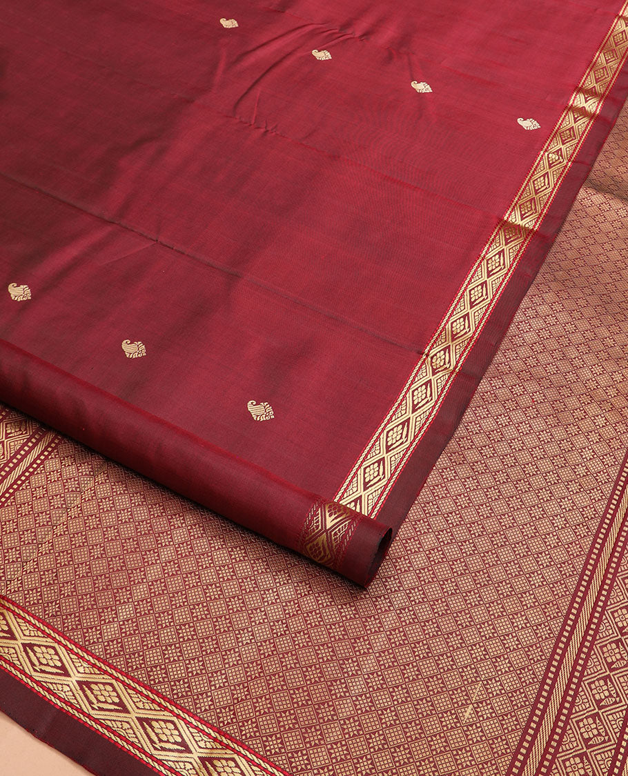 Maroon buttas Kanchipuram silk saree, self-border of diamond designs, and jaal pallu