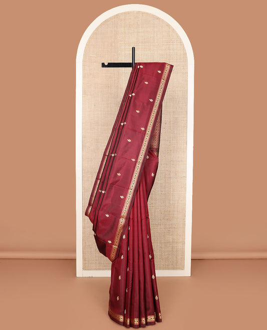 Maroon buttas Kanchipuram silk saree, self-border of diamond designs, and jaal pallu