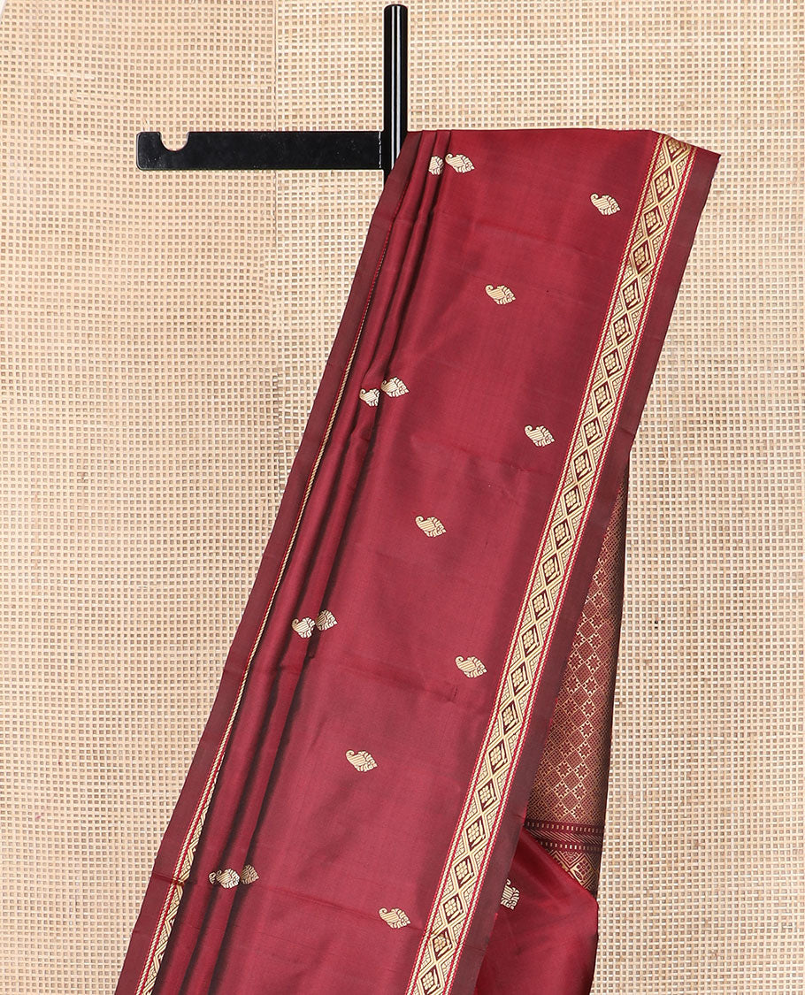 Maroon buttas Kanchipuram silk saree, self-border of diamond designs, and jaal pallu