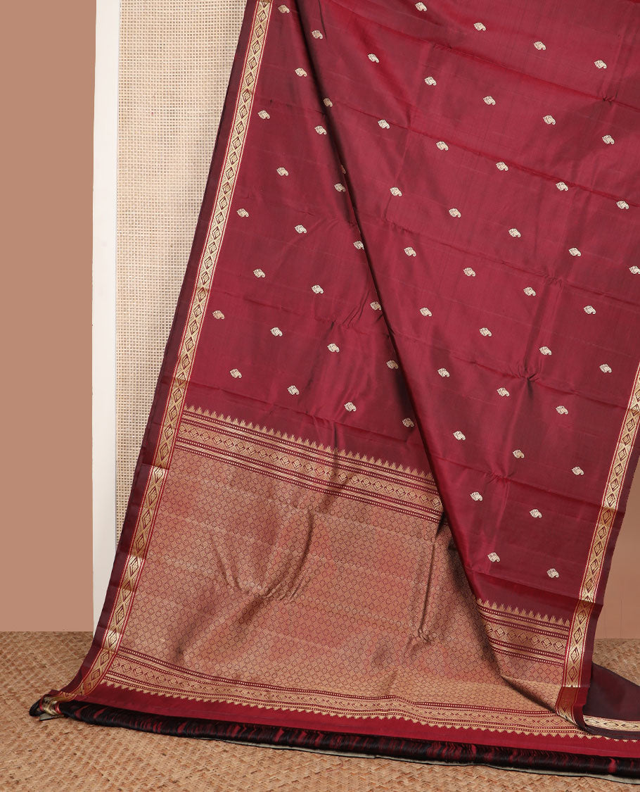 Maroon buttas Kanchipuram silk saree, self-border of diamond designs, and jaal pallu