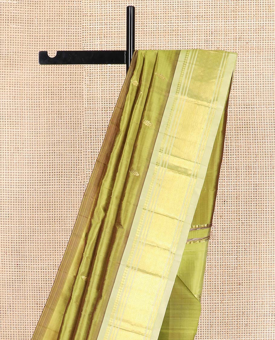 Green zari buttas Kanchipuram silk saree, contrast one-sided border of paneer sombu, banaras, and jaal designs, and floral design pallu