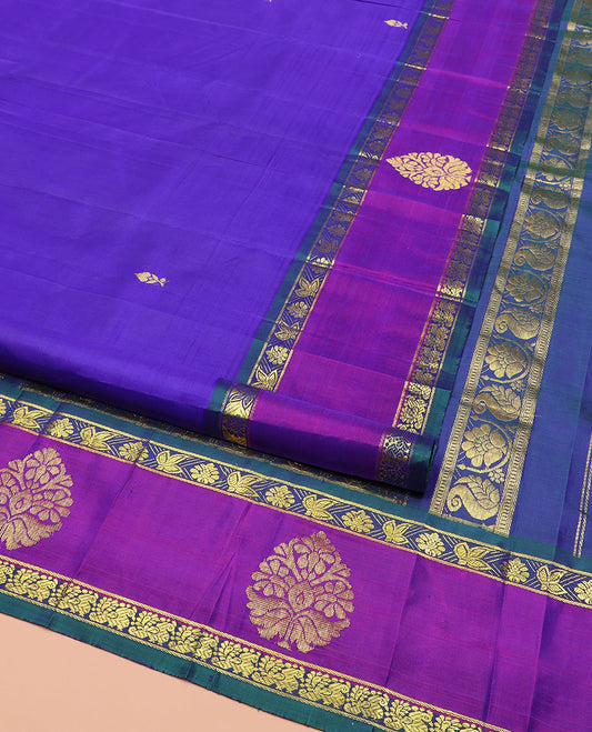 Blue Kanchipuram Silk Saree Decked Up with Zari Buttas All Over Its Body, Complemented by Contrast One-Sided Border of Floral Designs, Grandly Woven Pallu Steeped with Floral Designs, and Comes Without a Blouse