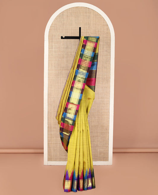 Yellow Kanchipuram Silk Saree, Subtly Sparkled with Zari Buttas, Complemented by Contrast Multi-Colored One-Sided Thazampoo Rekku Border of Zari Designs, Pallu Steeped with Vaira Oosi Stripes, and Comes Without a Blouse
