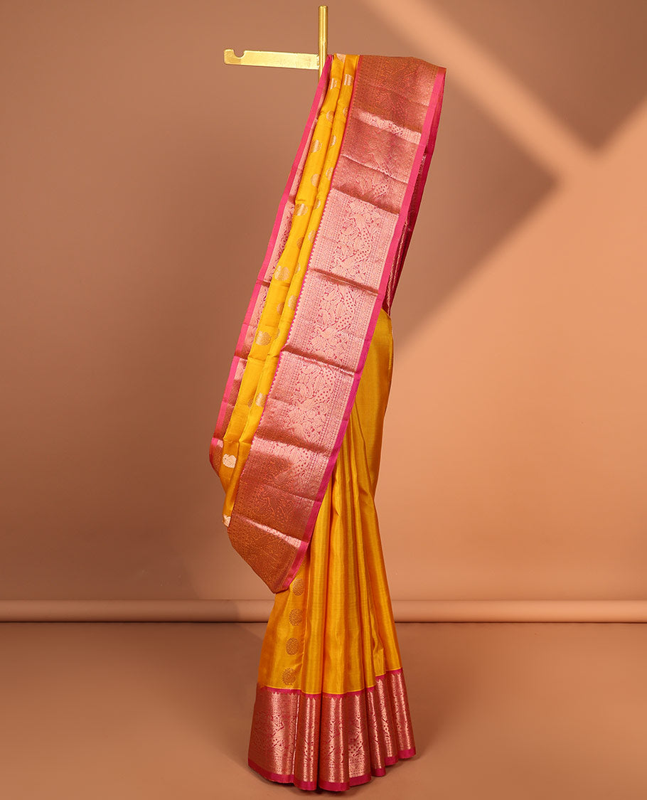 Yellow paisley kancheepuram silk saree with contrast border of sombu, muthu, paun, mayil design & zari design pallu