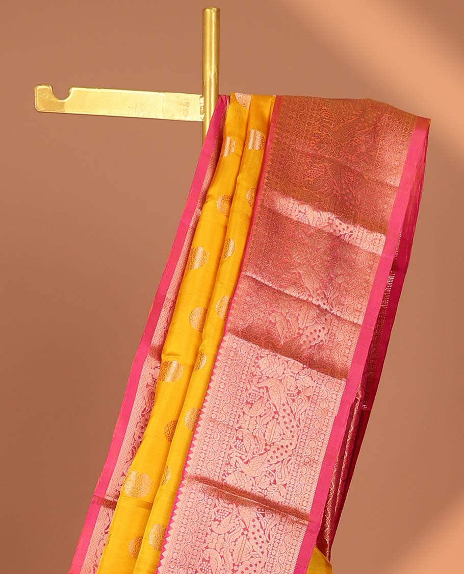 Yellow paisley kancheepuram silk saree with contrast border of sombu, muthu, paun, mayil design & zari design pallu
