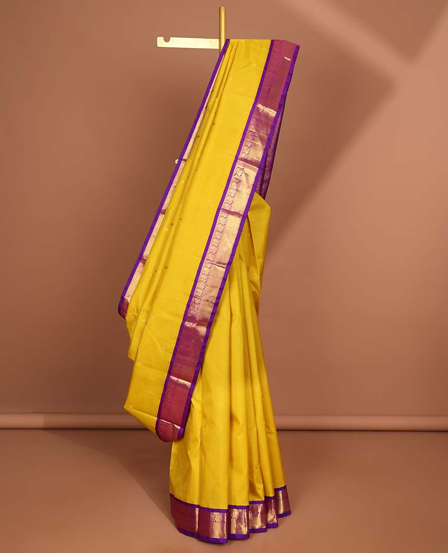 Yellow kancheepuram silk saree with intricate zari pallu & korvai border og rekku, muthu,mayil,mayil kann designs
