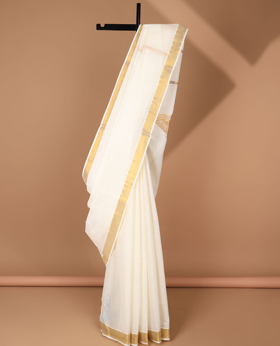 Cream kerala saree with zari designs, zari border & pallu of peacock designs