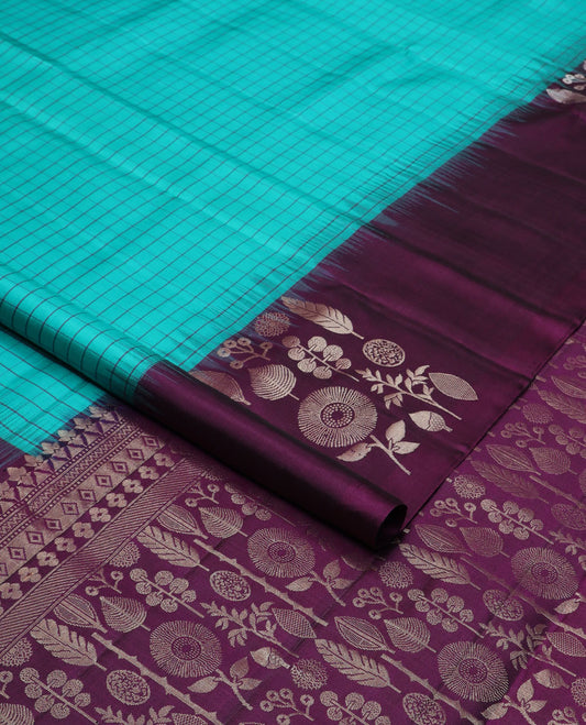 Blue checked soft silk saree, contrast unique-shaped floral & leaf motif border & pallu steeped with unique-shaped floral & leaf motifs