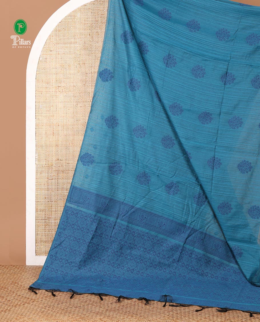 Borderless blue banaras jute silk saree with floral thread buttas woven all over it's body, intricate pallu & butta design blouse