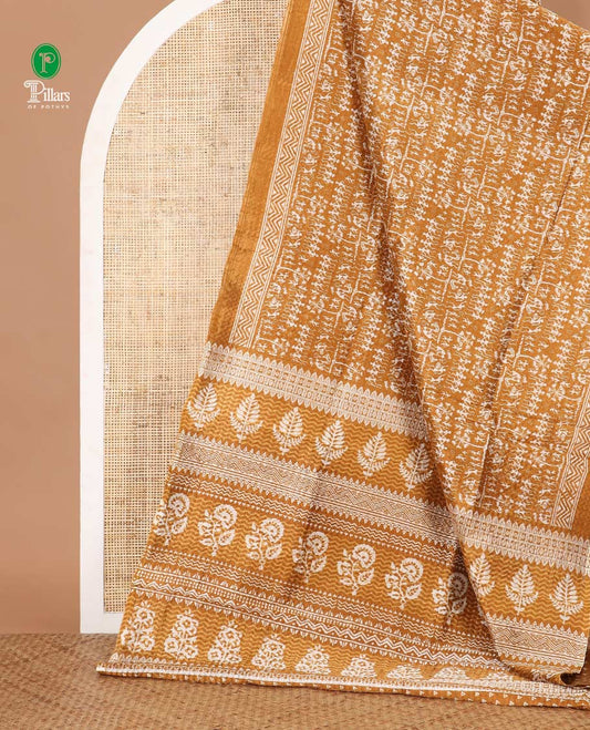 Mustard batik-style warli printed Litch crushed saree, batik chevron border, floral-geometric printed pallu & triangle motif blouse