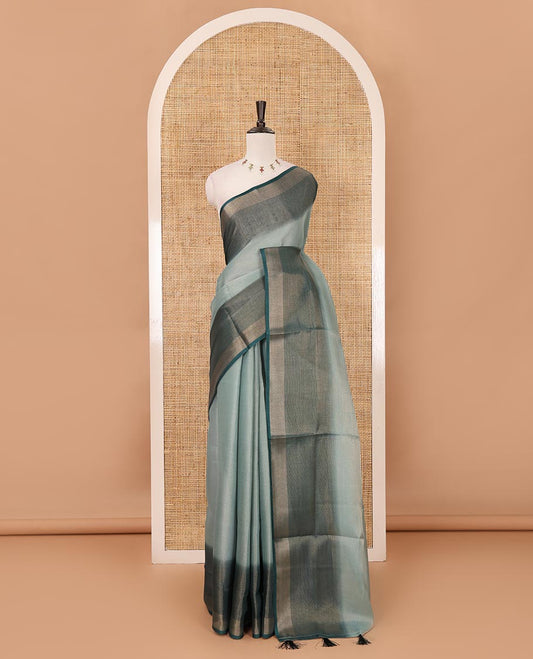 Green plain tissue saree, contrast gold zari piping border & self pallu with tussels