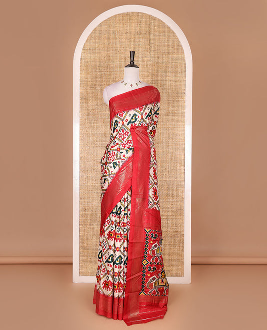 Half-white and red buttas enclosed jaal patterned patola-inspired pochampally dola silk saree, contrast red zari border, patola elephant pallu, and contrast blouse