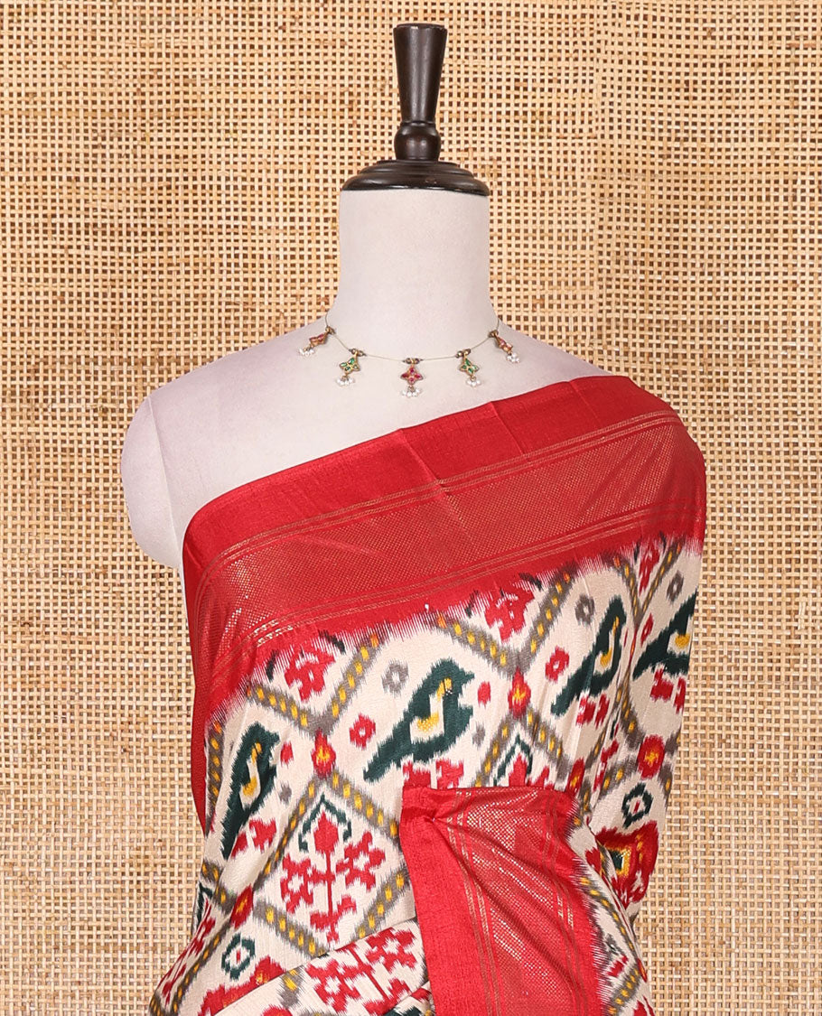 Half-white and red buttas enclosed jaal patterned patola-inspired pochampally dola silk saree, contrast red zari border, patola elephant pallu, and contrast blouse