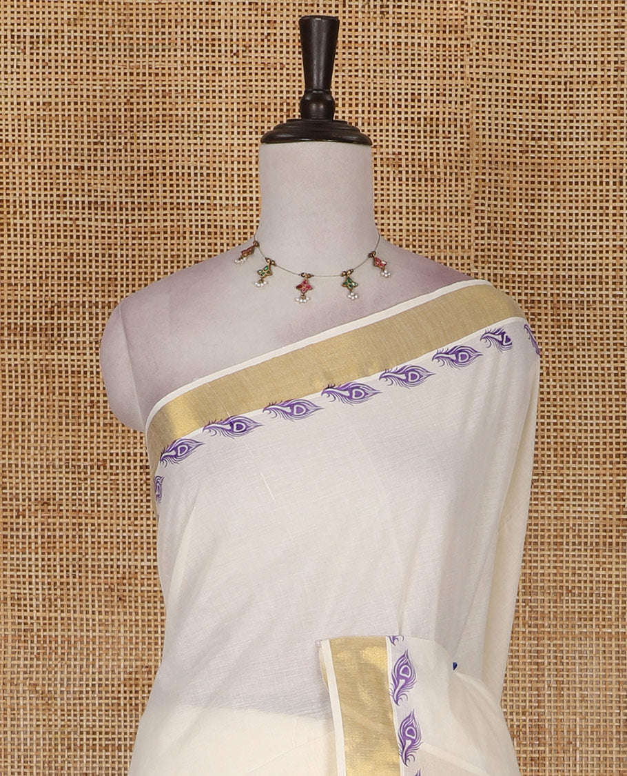 Half-white peacock feather motifs printed Kerala cotton saree, gold zari border, peacock feather printed pallu, and matching blouse