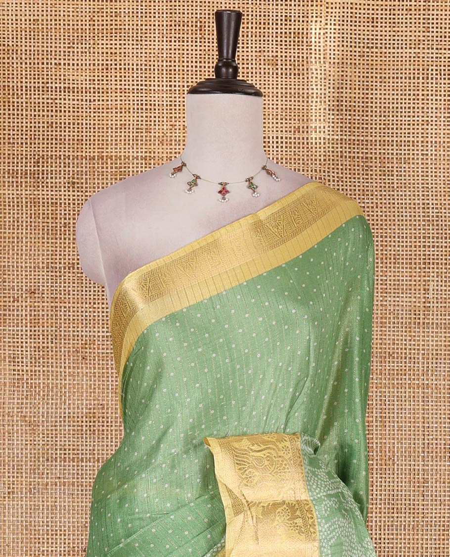 Green bandhani dotted trees, and deer motifs printed dola silk saree, contrast zari border, pallu of tree, and deer print, and contrast zari design blouse