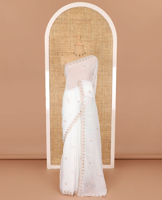 Half-white color, floral embroidered motifs crunchy crush saree, scallop pearl embroidered border,  embroidered pallu, and a contrast embroidered blouse