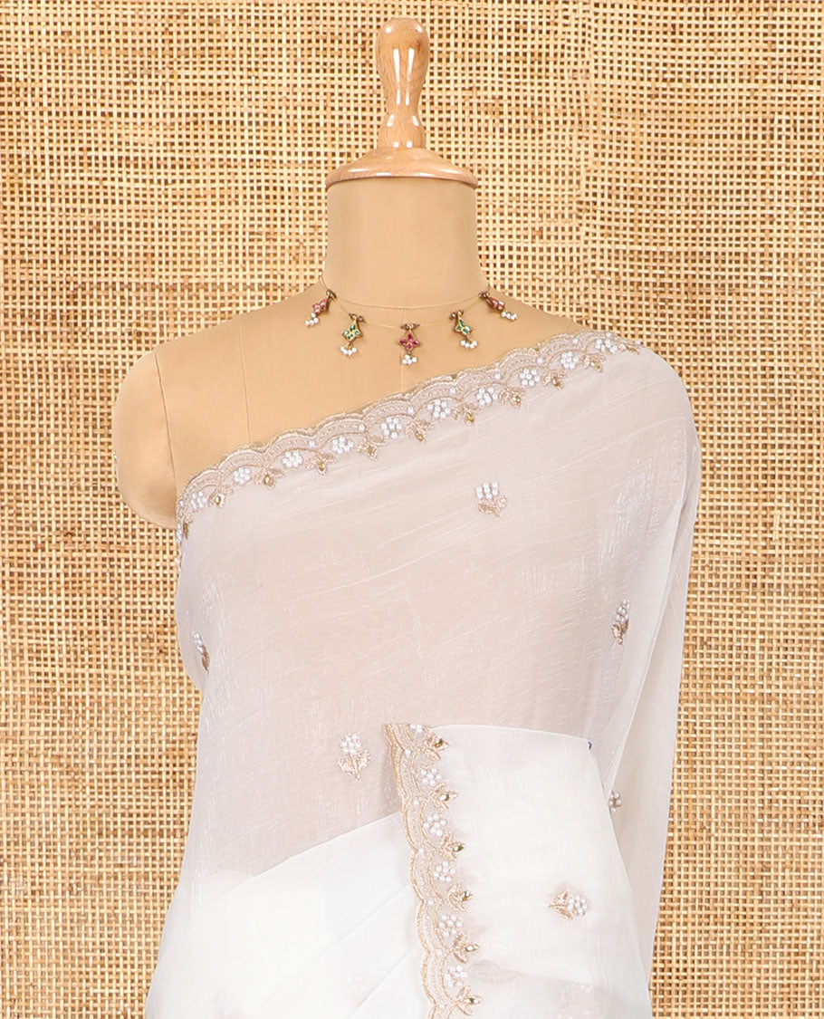 Half-white color, floral embroidered motifs crunchy crush saree, scallop pearl embroidered border,  embroidered pallu, and a contrast embroidered blouse