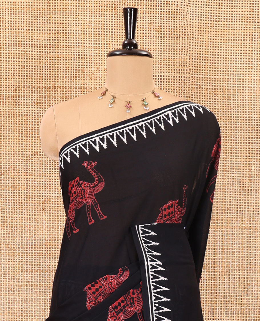 Black half-and-half style block printed soft mul cotton saree of camel and warli village print, temple border, geometric pallu, and a plain blouse