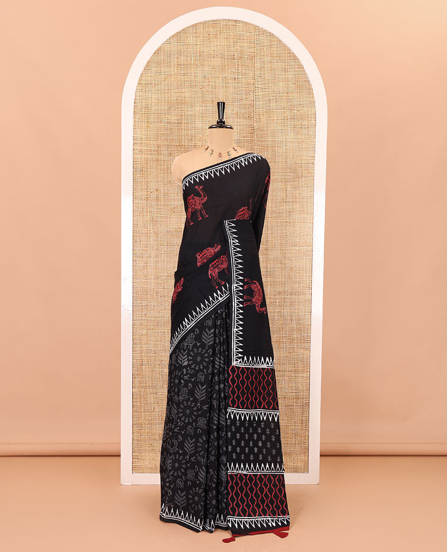 Black half-and-half style block printed soft mul cotton saree of camel and warli village print, temple border, geometric pallu, and a plain blouse