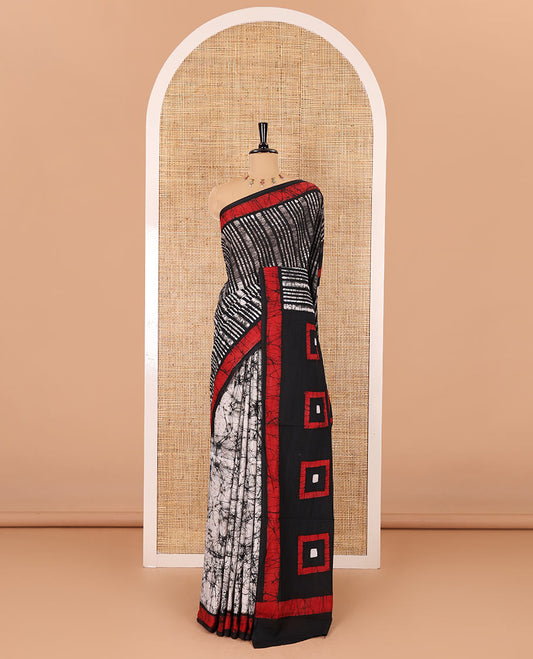 Black vertical stripes printed mul cotton saree, contrast batik printed border, pallu of geometric batik print, and a contrast printed blouse