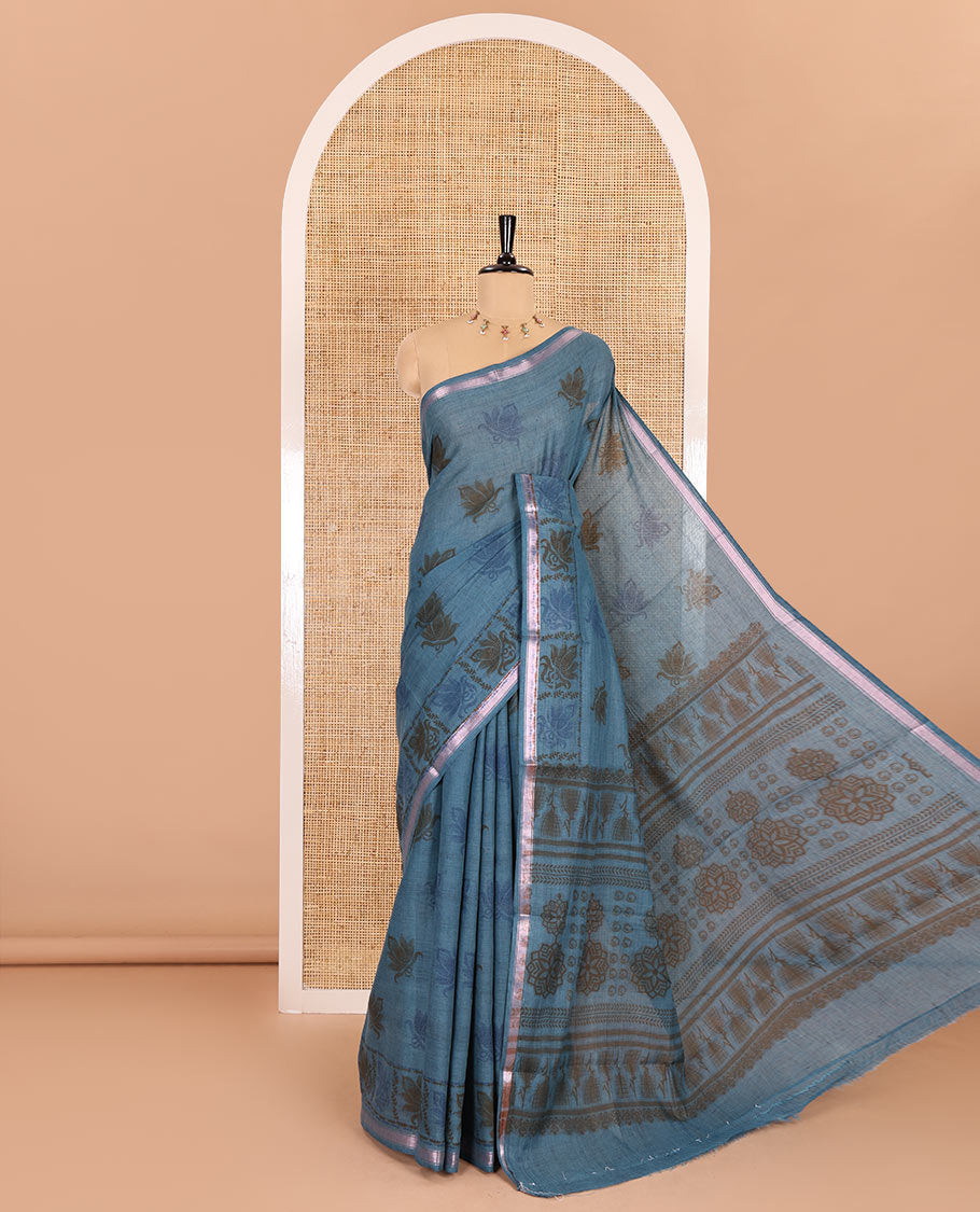 Sky blue lotus printed soft cotton saree, piping border, printed pallu, and a shibori printed blouse of polka dots
