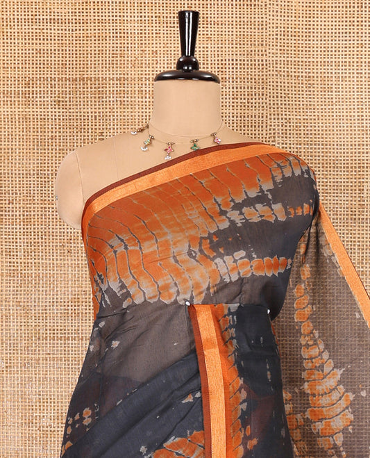 Black shibori printed muslin cotton saree, contrast gold zari border, shibori printed pallu, and shibori printed blouse